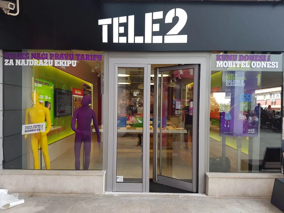Illuminated sign and window graphics on a retail store