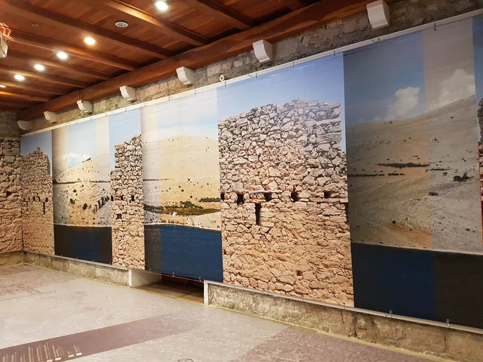 Large-format wall photos of Kornati dry-stone walls in an exhibition