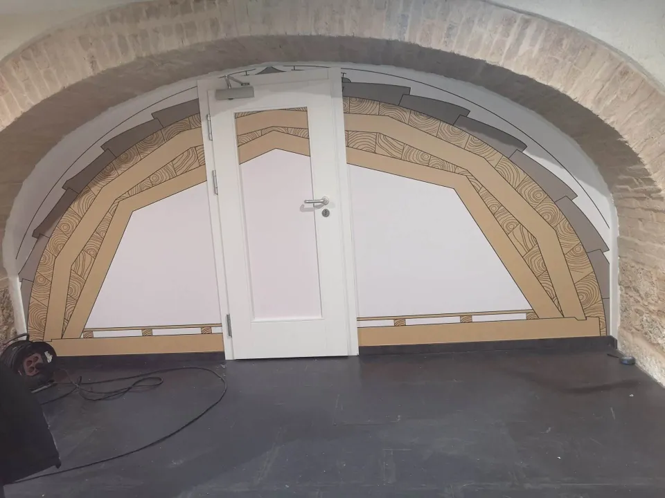 Custom cladding of an arched opening with a door and wooden panels